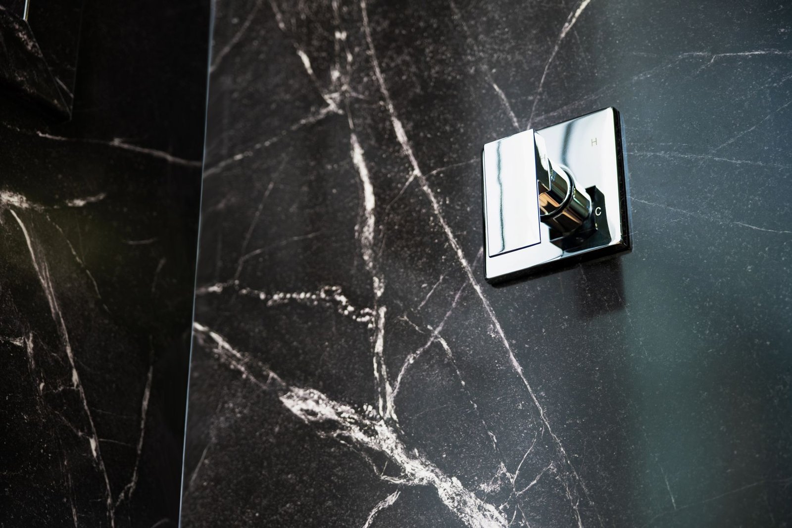 Close detail of solid surface panel and valve trim