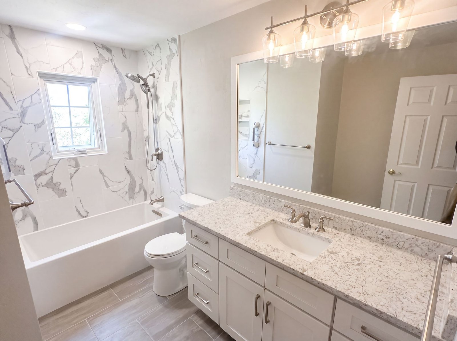 Full bathroom remodel with tub, vanity and quartz top